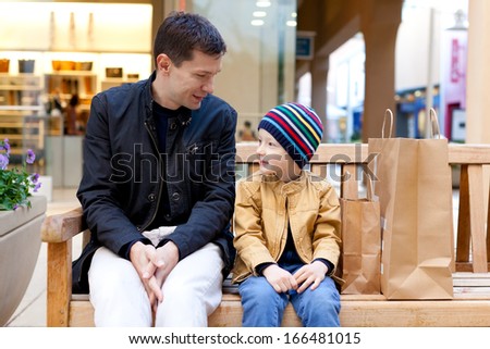 cheerful smiling family of two shopping together