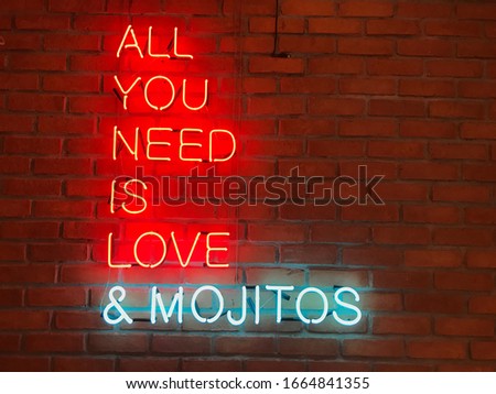 colorful red single written with led light on brick wall writes love you need and mojito wonderful background image LED electricity technology industry lifestyle.