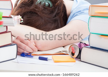 Tired student sleeping after studying before an exam