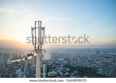 Telecommunication tower with 5G cellular network antenna on city background Royalty-Free Stock Photo #1664898070