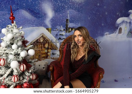 Holidays. Beautiful blonde girl posing in studio. Winter, Christmas, celebration concept.