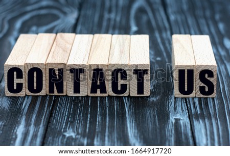concept of words to contact us on cubes on a beautiful wooden background
