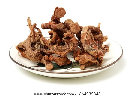 Alpinia officinarum, known as lesser galangal, or Havlucan. Dried Root. Isolated on white background stock photo