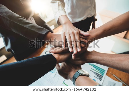 Teamwork Success.  Business people group team happy showing teamwork and joining hands after meeting partner business in office. Business Concept