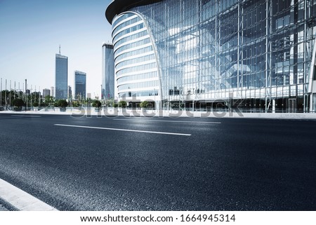 Asphalt road High way Empty curved road clouds and sky at sunset Royalty-Free Stock Photo #1664945314
