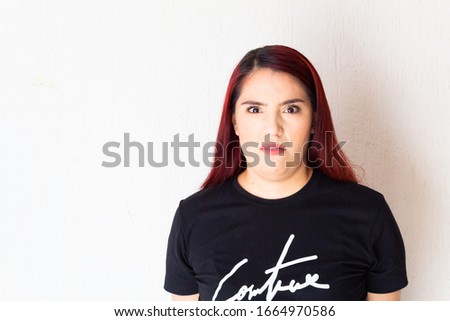 Hispanic white-skinned redhead woman showing anger, frustration, anger and other negative emotions on a white background