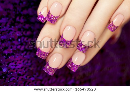 Aquarium nail with blue chips and gold sequins in female hands. Royalty-Free Stock Photo #166498523