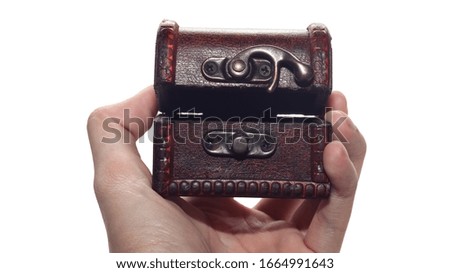 Hand is holding small treasure box  with clipping mask isolated on white background                            