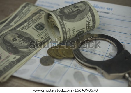 Economic crime concept.Police Handcuffs on fingerprints crime page file.