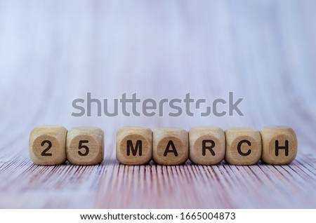 Date March 25, wooden cubes. Days of the month wooden cubes concept