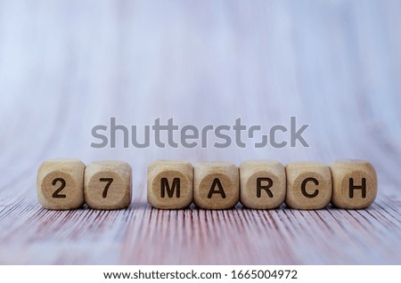 Date March 27, wooden cubes. Days of the month wooden cubes concept