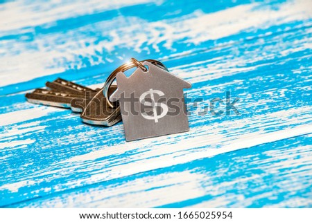 The symbol of the house lies on a blue wooden background