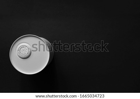 White oil barrel closed with a cork on a dark black background. Flat lay. Copy space.