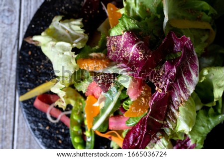 A top down view of a rustic colorful salad.