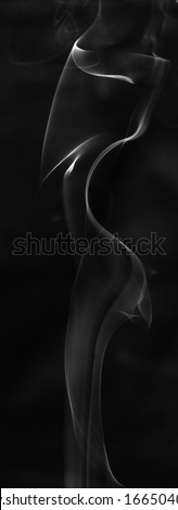 Incense smoke shot against a black background