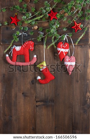 christmas decoration textile handmade toys over rustic wooden background. nostalgic picture with retro style design