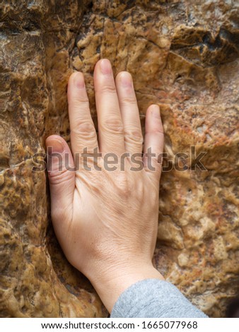 Jerusalem/Israel - December 30 2019: An old square stone, located near Station V on Via Dolorosa, has a cavity which is said to be the imprint of Jesus hand.