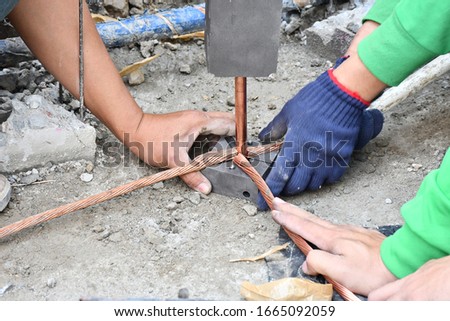 Workers are working connect ground wire protection system.