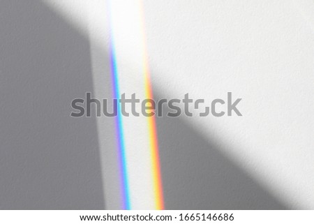 Blurred overlay effect for photo and mockups. Wall texture with organic drop diagonal shadow and rays of light from window on a white wall.