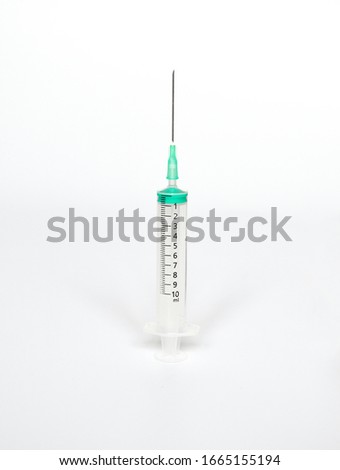 Empty transparent plastic syringe size 10 ml. on white background with space for text. A tube for sucking in and ejecting liquid in a thin stream. Healthy care,medical and beauty object concept. Royalty-Free Stock Photo #1665155194