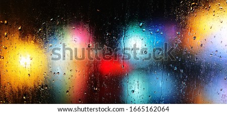 A beautiful view of rain droplets from car window.