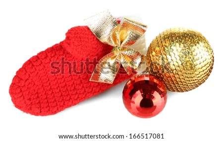 Red winter mitten with Christmas toys isolated on whited