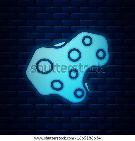 Glowing neon Asteroid icon isolated on brick wall background.  Vector Illustration
