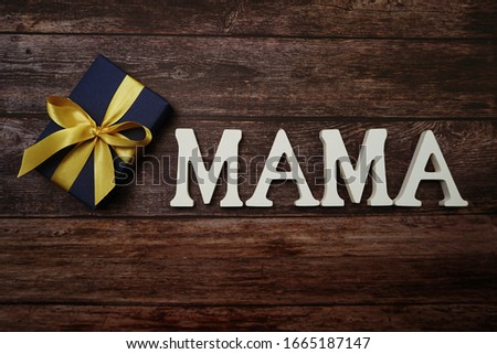 MAMA alphabet letter on wooden background
