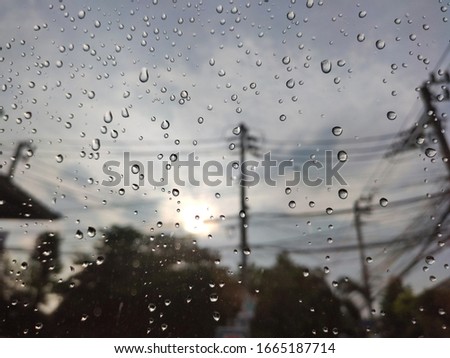 Rain drop on car windshield with blurred background , selective focus
