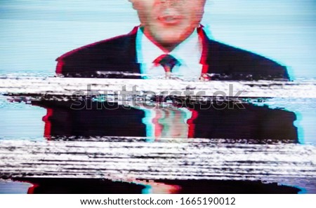 Man in a suit on the screen. Broadcaster. Glitch. Digital errors on the screen. 