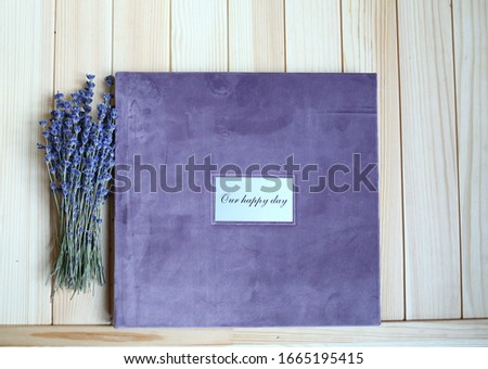 
album photo book with a metal insert and an inscription in a villa cover with a decor next to the flowers in a small pot