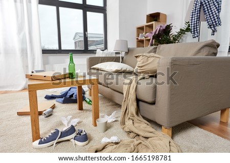 mess, disorder and interior concept - view of messy home living room with scattered stuff Royalty-Free Stock Photo #1665198781