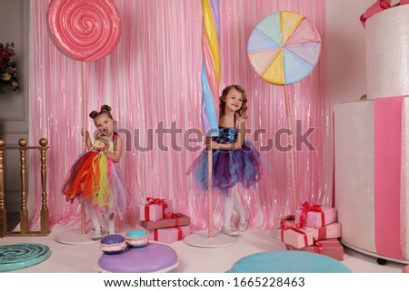 themed children's parties, model girls have fun at a birthday party in a beautiful, delicious, pink candy interior, participate in a competition, the overall plan.