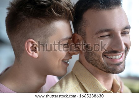 Happy smiles. Close up picture of gay couple smiling happily