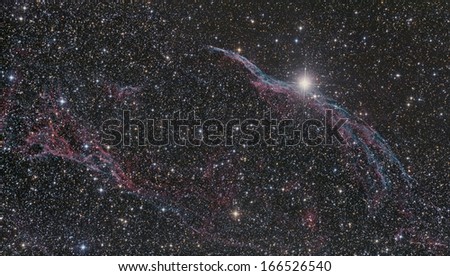Veil Nebula (NGC 6960) in Swan Constellation against starry night dark sky