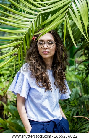Woman. Photo shoot with tropical plants