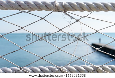 Blue ocean and clear through white ropes from the shore, good warm spring weather. Freedom concept.