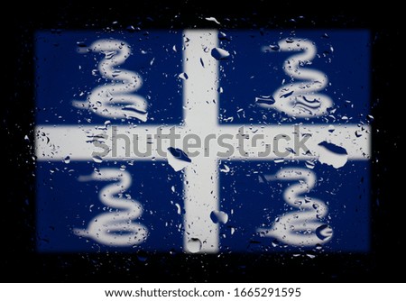 State flag of Martinique. Abstract photo with water drops on glass. Isolated on black background.