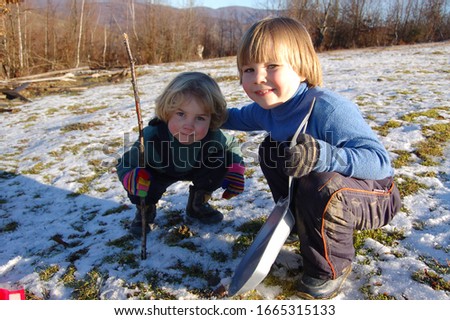 Children with sled playing brothers