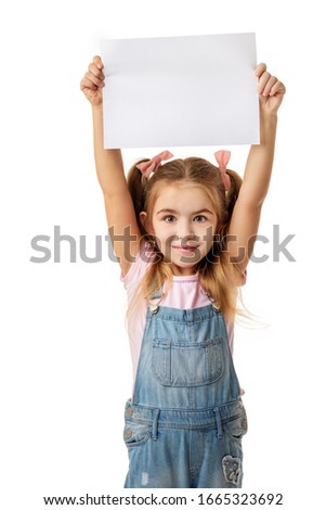 Happy cute child holding empty blank isolated on white background. kid with placard board for your text. girl with white sheet of paper. copy space