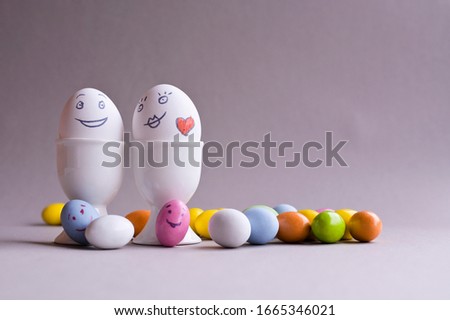 Eggs with a face. Mom, dad and a lot of little colored kids eggs. The idea for decorating Easter Sunday. Copy space 