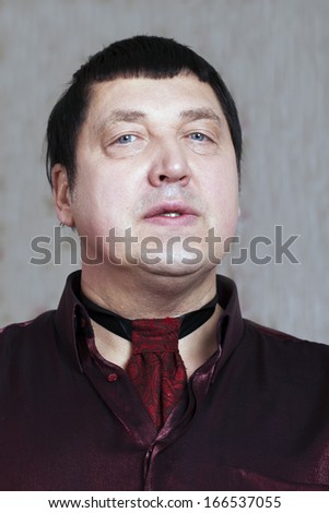 Portrait of man in red shirt.
