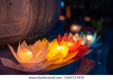 Colored lanterns and garlands at night on Vesak day for celebrating Buddha's birthday in Eastern culture, that made from paper and candle Royalty-Free Stock Photo #1665373435