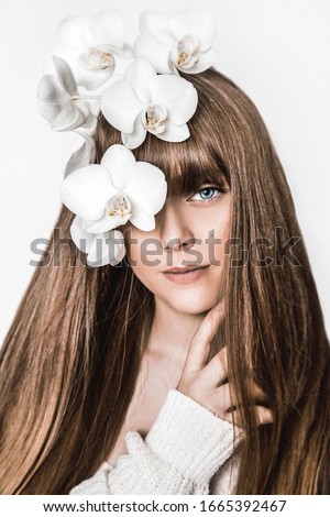 Beauty portrait of young natural model with perfect long healthy hairstyle isolated on white posing in studio. Pretty girl with stylish smooth haircut and natural makeup. Hairstyle and makeup concept.