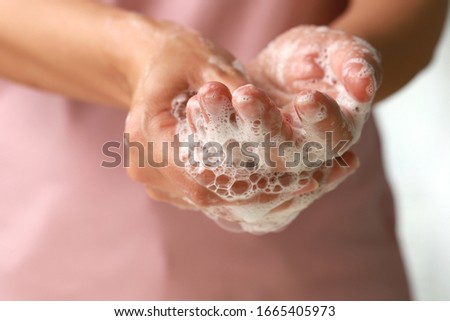 Close up female washing hand with soap. Good personal hygiene practices. Royalty-Free Stock Photo #1665405973