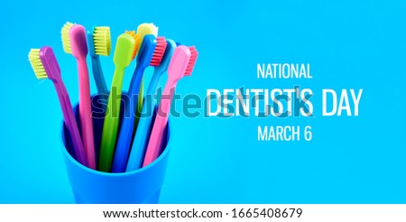 National Dentist's Day images. Colored toothbrushes stock images. Morning hygiene images. Bathroom accessories images. Toothbrush on a blue background. Dentists Day Poster, March 6. Important day
