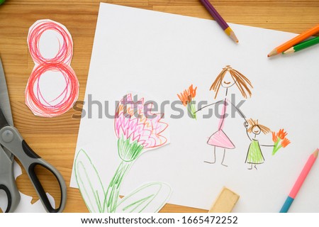 Background for Women's Day. Greeting card international women's day March 8.
Children's drawing, colored pencils lie on the table.
Number 8 cut from paper on background.
Cut from paper. creativity