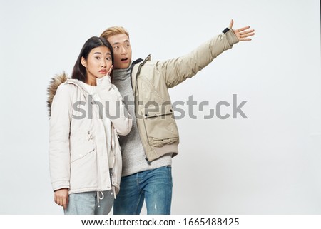 Beautiful young couple of Asian appearance winter studio lifestyle
