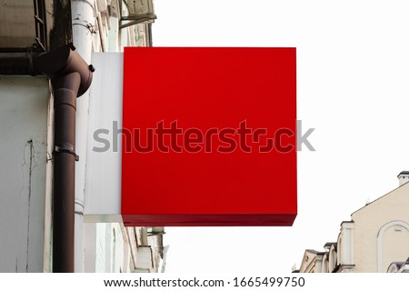 Signboard mockup. Red square sign shop on the wall of the house. Layout for creativity and design.