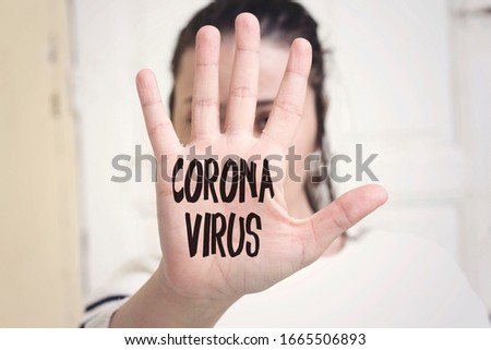 coronavirus concept painted in the palm of a young caucasian woman Royalty-Free Stock Photo #1665506893